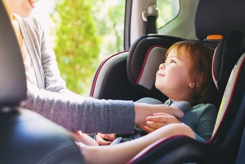 Think to the future - Toddler girl buckled into her car