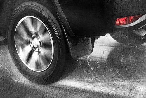 Detail of the rear wheel of a car driving in the rain Perth City Skoda