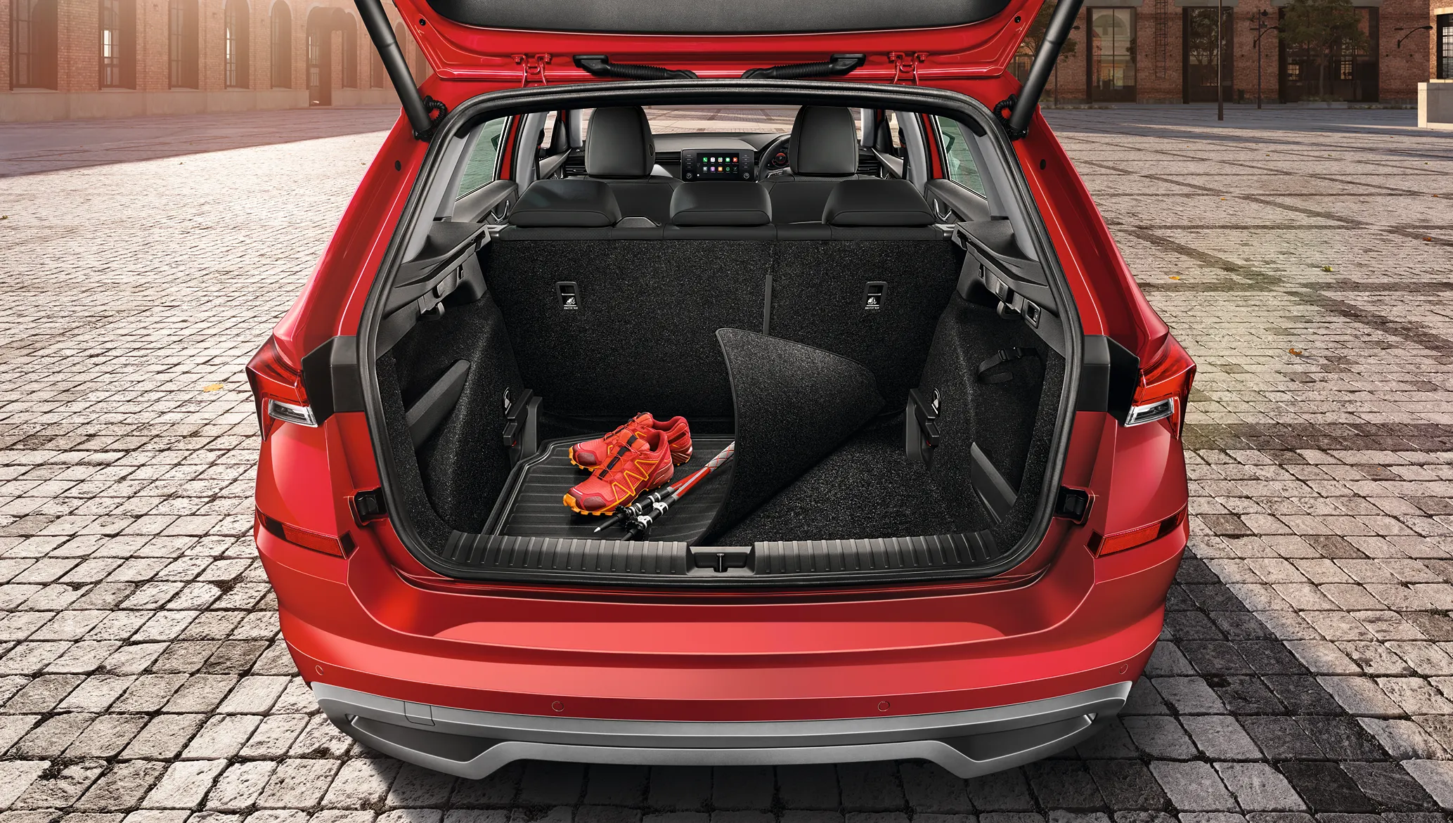 Red Skoda with open trunk and folded seats