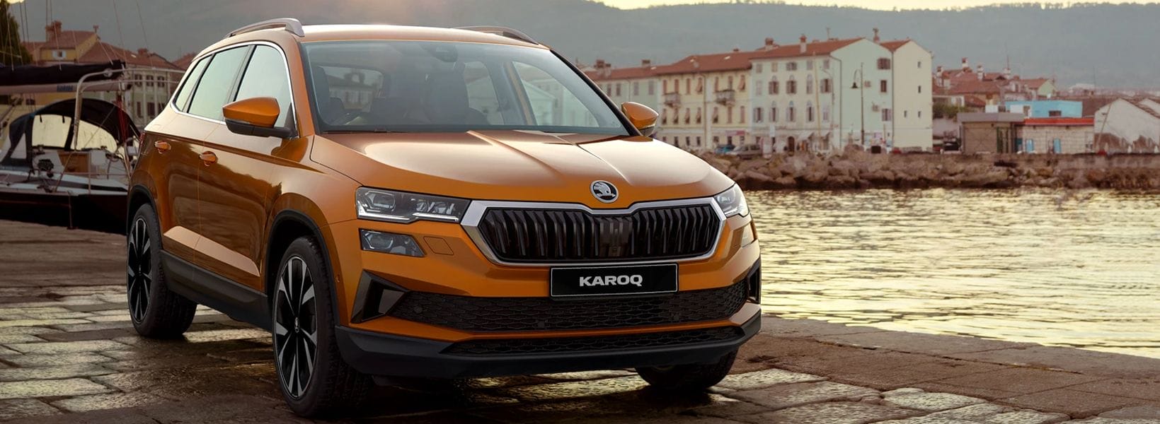 Orange Skoda Karoq parked by the seafront