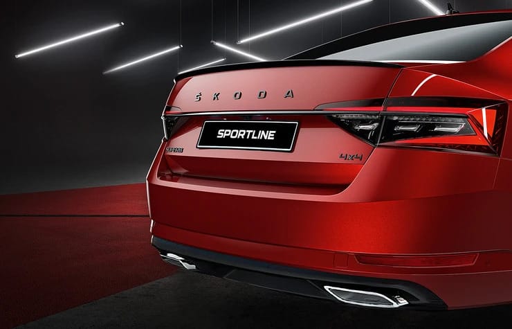 Rear view of 2024 Škoda Superb Sportline 4x4 sedan in red showcasing gloss black rear badge, 4x4 badging and twin exhaust – overseas model shown.