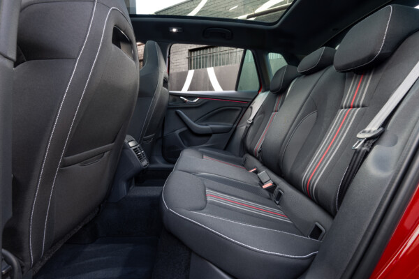 A modern Skoda Karoq SUV in a distinctive mustard yellow finish