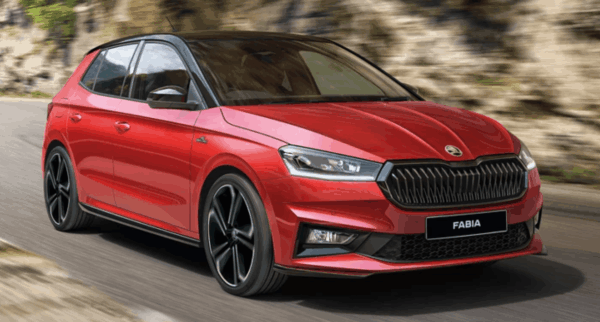 Dynamic front-side view of a red Škoda Fabia hatchback in motion, emphasising its sporty design and sharp LED headlights